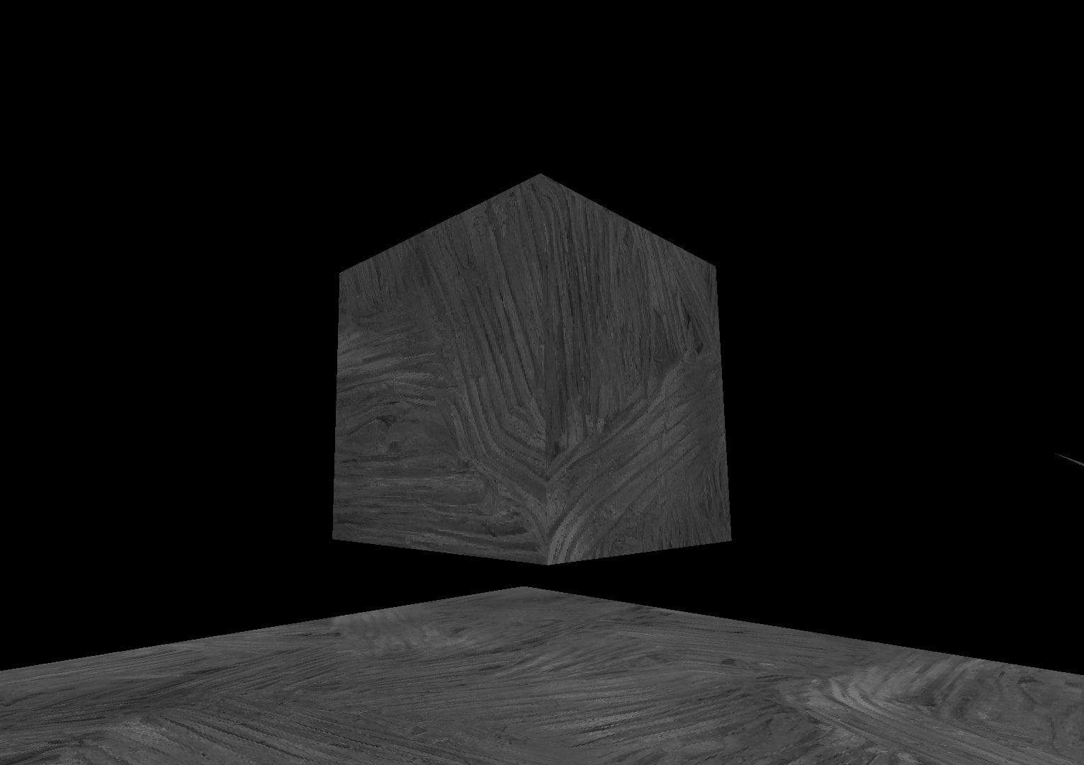 A screenshot of a cube rendered in Three.JS.  It's textured with a gray stone-like pattern and floating above a platform made of the same material.  The background is pure black.
